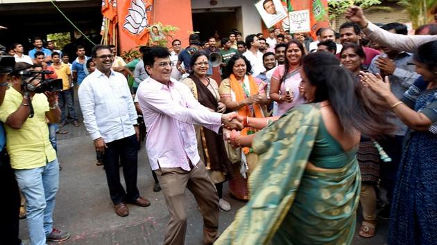 HAND-IN-HAND: BJP MP Kirit Somaiya celebrates outside the BJP office in Dadar. (Kunal Patil/HT photo) 