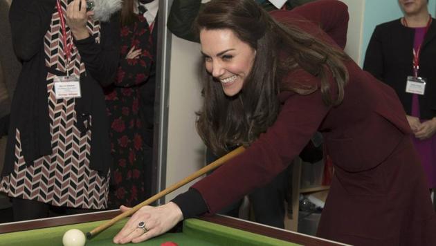 Britain's Catherine, Duchess of Cambridge, plays pool during her visit to MIST, a child and adolescent mental health project in Pontypool. (Paul Edwards / pool / REUTERS)