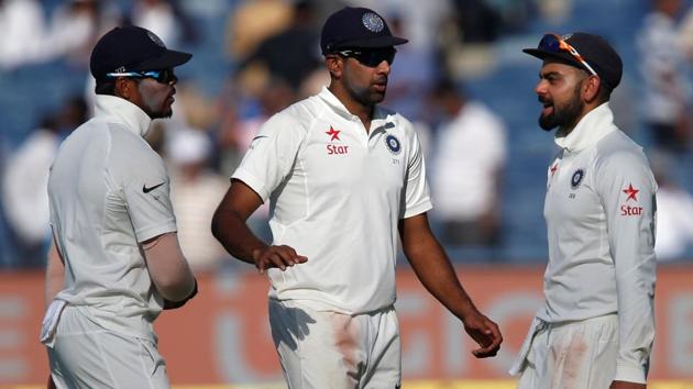 Virat Kohli, Ravichandran Ashwin and Umesh Yadav walk off the ground at the end of the first day's play in Pune on Thursday. Live streaming and live cricket score of Day 2 of India vs Australia is available online.(REUTERS)