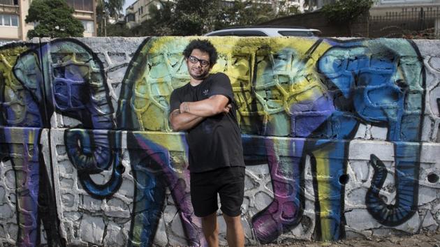 Artist Falko One poses with his mural near Mount Mary in Bandra(Satish Bate/HT Photo)