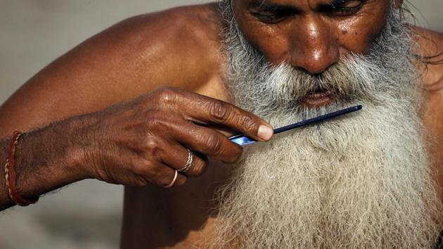 A Hindu holy man combs his beard in the courtyard of Pashupatinath temple in Kathmandu. (Niranjan Shrestha / AP) A Hindu holy man combs his beard in the courtyard of Pashupatinath temple in Kathmandu. (Niranjan Shrestha / AP)