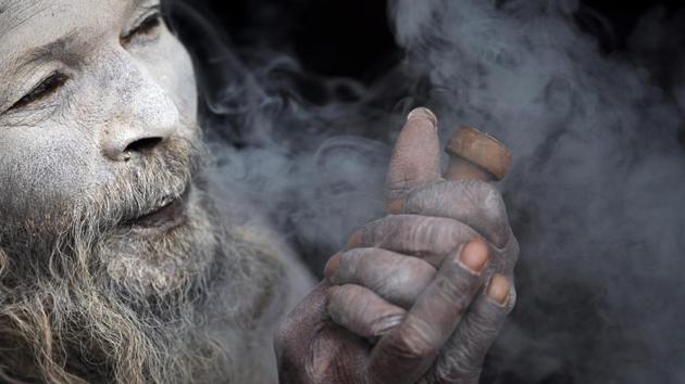 One can view the scenes of Sadhus with their faces smeared with firewood ashes and puffing on cigarettes mixed with marijuana . (Niranjan Shrestha / AP) One can view the scenes of Sadhus with their faces smeared with firewood ashes and puffing on cigarettes mixed with marijuana . (Niranjan Shrestha / AP)