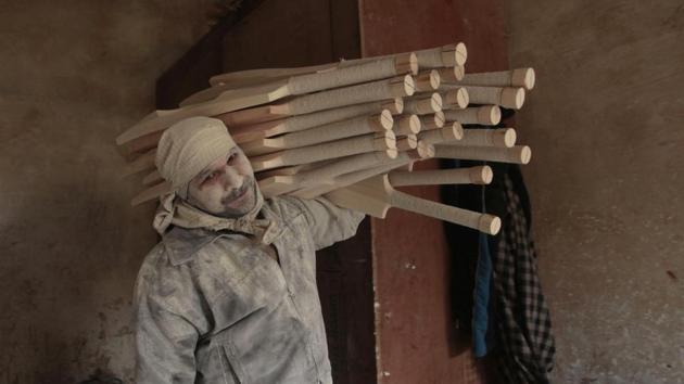 Carrying the semi-finished bats for lamination and polishing. (Waseem Andrabi / HT Photo)