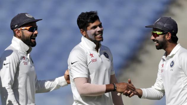 India's Umesh Yadav (centre) celebrates the wicket of Nathan Lyon with Virat Kohli (left) and Ajinkya Rahane on the first day of the first Test in Pune, on Thursday.(AP)