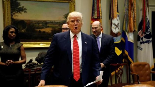 US President Donald Trump takes his seat for a "strategic initiatives" lunch at the White House in Washington. (Reuters Photo) US President Donald Trump takes his seat for a "strategic initiatives" lunch at the White House in Washington. (Reuters Photo)