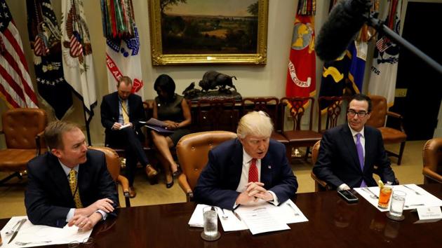 Director of the office of management and budget Mick Mulvaney (L) and treasury secretary Steve Mnuchin (R) with US President Donald Trump at the White House in Washington on Tuesday. (Reuters Photo) Director of the office of management and budget Mick Mulvaney (L) and treasury secretary Steve Mnuchin (R) with US President Donald Trump at the White House in Washington on Tuesday. (Reuters Photo)