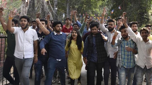 Students and members of ABVP shout slogans at Ramjas College on Tuesday.