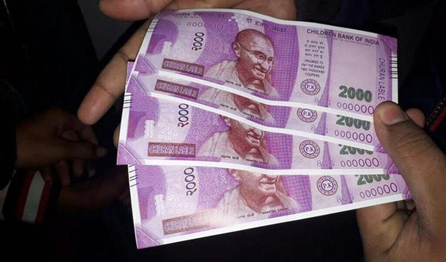 Fake Rs 2000 notes dispensed by a State Bank of India ATM in south Delhi’s Sangam Vihar. The notes carried the name of ‘Children Bank of India’.(PTI Photo)
