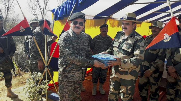 BSF and Pakistan Rangers officers exchange sweets after their meeting at Kathua in Jammu on Friday. (PTI) BSF and Pakistan Rangers officers exchange sweets after their meeting at Kathua in Jammu on Friday. (PTI)