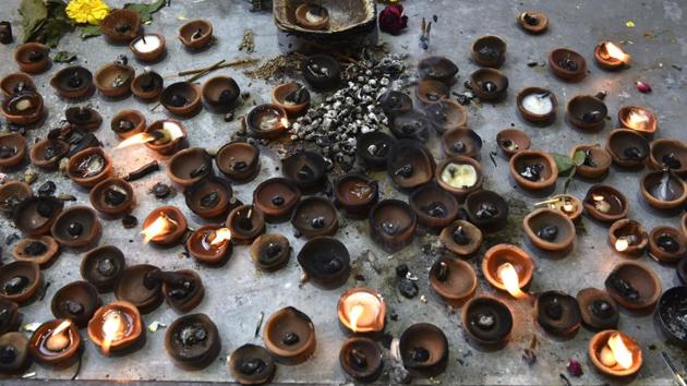 Incense sticks and diyas after morning prayers at the temple. (Saumya Khandelwal/HT PHOTO)