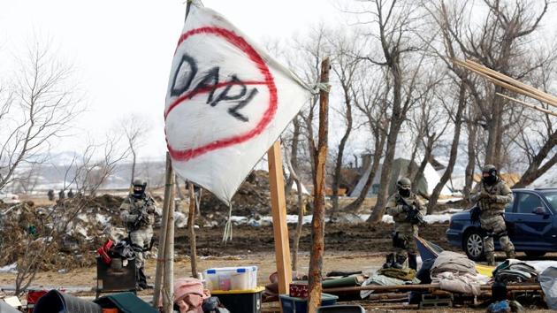 It took 3 ½ hours for about 220 officers and 18 National Guardsmen to methodically search the protesters’ temporary homes and arrest people, including a man who climbed atop a building and stayed there for more than an hour before surrendering. (Terray Sylvester/REUTERS)