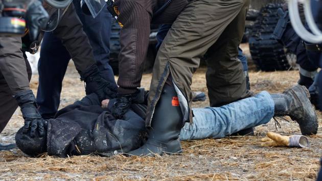 Police detain a protester in the main opposition camp. The Army Corps of Engineers said it needed to clear the camp ahead of spring flooding, and had ordered everyone to leave by 2 p.m. Wednesday. (Terray Sylvester/REUTERS)