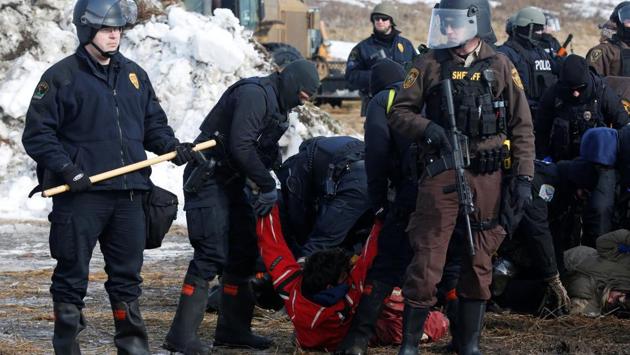 Police detain Ricardo Salazar, 25, of San Bernardino, California. At its height, the camp included thousands of people, but the numbers had dwindled during the winter and as the fight over the pipeline moved into the courts. (Terray Sylvester/REUTERS)