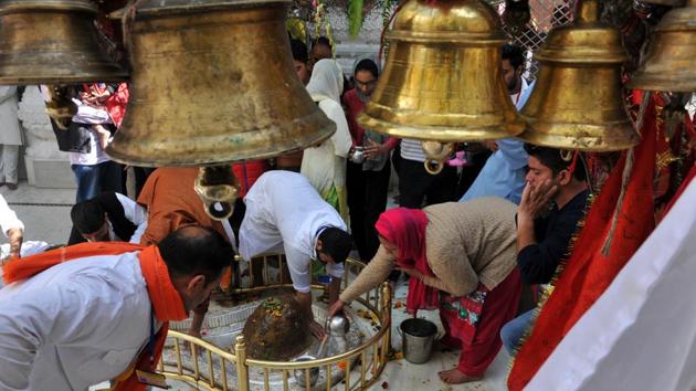 Devotees offer milk in temple during Maha Shivratri festival, in Jammu, on Friday. (Nitin Kanotra/HT Photo)