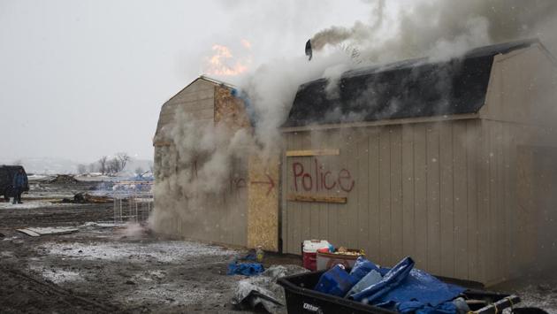 Structures are burned at the Oceti Sakowin protest camp before a 2 p.m. deadline to vacate in Cannon Ball, N.D., Feb. 22, 2017. A dwindling band of activists protesting the Dakota Access oil pipeline remained camped along the banks of the Missouri River as a Wednesday afternoon deadline for them to leave had passed. (Nick Cote/The New York Times) (Nick Cote/NYT)