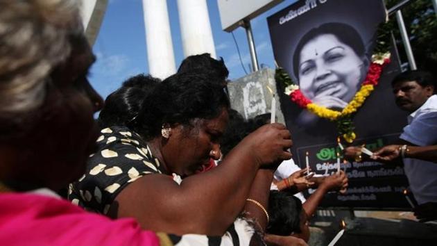 Supporters of Tamil Nadu chief minister Jayalalithaa Jayaraman light candles in front of her picture as they pay homage outside Jayalalithaa's burial site in Chennai, India, December 7. (Reuters) Supporters of Tamil Nadu chief minister Jayalalithaa Jayaraman light candles in front of her picture as they pay homage outside Jayalalithaa's burial site in Chennai, India, December 7. (Reuters)