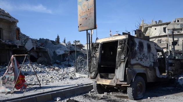 A general view shows a burnt out vehicle on a destroyed street in the northwestern border town of al-Bab on February 23, 2017 after Turkish-backed Syrian rebels fully recaptured the town from the Islamic State (IS) group.(AFP) A general view shows a burnt out vehicle on a destroyed street in the northwestern border town of al-Bab on February 23, 2017 after Turkish-backed Syrian rebels fully recaptured the town from the Islamic State (IS) group.(AFP)