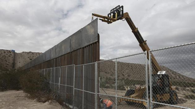 In this November 10, 2016, file photo, workers continue work raising a taller fence in the Mexico-US border area separating the towns of Anapra, Mexico and Sunland Park. (AP File Photo) In this November 10, 2016, file photo, workers continue work raising a taller fence in the Mexico-US border area separating the towns of Anapra, Mexico and Sunland Park. (AP File Photo)