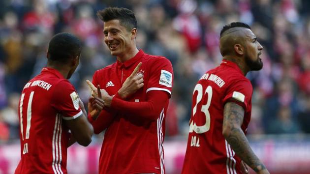 Bayern Munich's Robert Lewandowski (centre) celebrates after his hat-trick against Hamburg SV in their Bundesliga match on Saturday. (REUTERS) Bayern Munich's Robert Lewandowski (centre) celebrates after his hat-trick against Hamburg SV in their Bundesliga match on Saturday. (REUTERS)