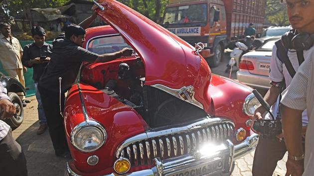 Well-oiled wheels:  A driver inspects a red Buick  before the rally begins. (Pratik Chorge/HT PHOTO) 