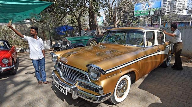 Auto‘mobile’ moment:  A man takes a selfie in front of a car. (Pratik Chorge/HT PHOTO) 