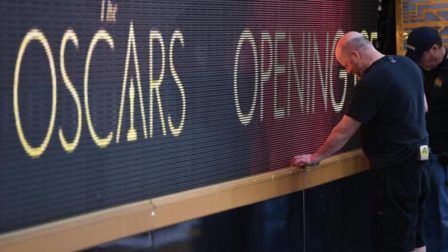 A man giving final touches to the big screen. (AFP)