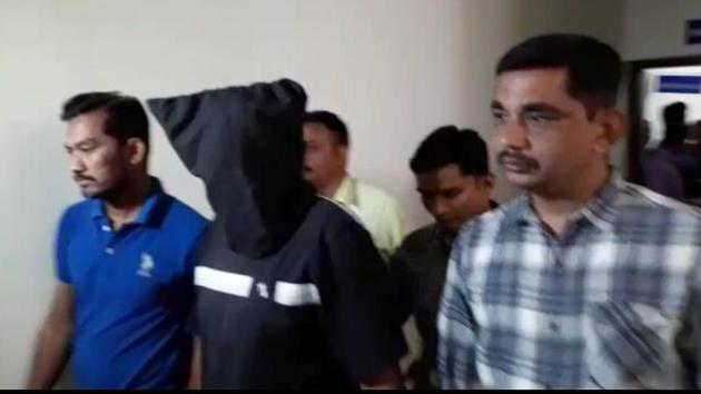 ATS personnel take one of the brothers, accused of having Islamic State links, into custody. (HT Photo) ATS personnel take one of the brothers, accused of having Islamic State links, into custody. (HT Photo)
