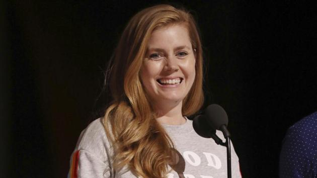 Amy Adams, who got snubbed for the best actress award nomination, seen smiling on stage. (Matt Sayles/Invision/AP)