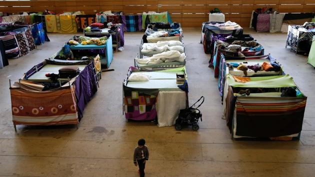 A migrant child walks at the sports hall of the Jane-Addams high school that was transformed into a refugee shelter in Berlin's Hohenschoenhausen district, Germany. (Reuters File Photo) A migrant child walks at the sports hall of the Jane-Addams high school that was transformed into a refugee shelter in Berlin's Hohenschoenhausen district, Germany. (Reuters File Photo)