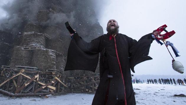Artist German Vinogradov performs during the Maslenitsa festival at the Nikola-Lenivets art park. (Denis Tyrin / AP)