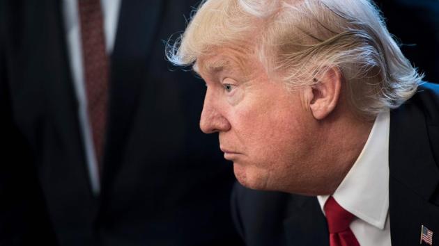 US President Donald Trump pauses before signing an executive order about regulatory reform in the Oval Office of the White House. (AFP Photo)
