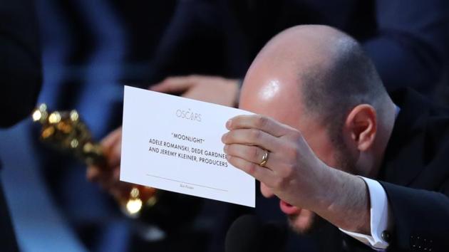 Producer Jordon Hurwitz holds up the card for the Best Picture winner Moonlight.(REUTERS)