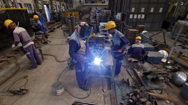 Employees make iron parts for bridges at a manufacturing unit in an industrial area on the outskirts of Kolkata. (Reuters File) Employees make iron parts for bridges at a manufacturing unit in an industrial area on the outskirts of Kolkata. (Reuters File)