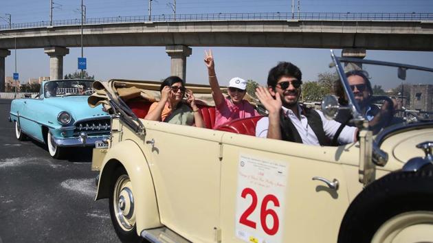 Participants flash victory sign during the 19th Vintage & Classic Car Rally, that was flagged off from Jai Mahal Palace.