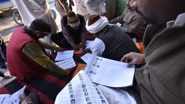 Poring over voter lists at a polling station at Ayodhya. An estimated 12 to 13% of voters turned out to exercise their franchise till 10am across these districts. (Arun Sharma/HT PHOTO) Poring over voter lists at a polling station at Ayodhya. An estimated 12 to 13% of voters turned out to exercise their franchise till 10am across these districts. (Arun Sharma/HT PHOTO)