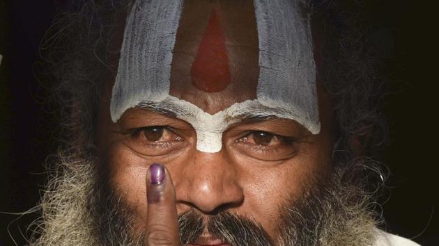 A Sadhu shows his inked finger after casting his vote at a polling booth during elections in Ayodhya on 27th February 2017. The 5th phase of polling for 51 assembly seats is spread across 11 districts in Uttar Pradesh. (Arun Sharma/HT PHOTO) A Sadhu shows his inked finger after casting his vote at a polling booth during elections in Ayodhya on 27th February 2017. The 5th phase of polling for 51 assembly seats is spread across 11 districts in Uttar Pradesh. (Arun Sharma/HT PHOTO)
