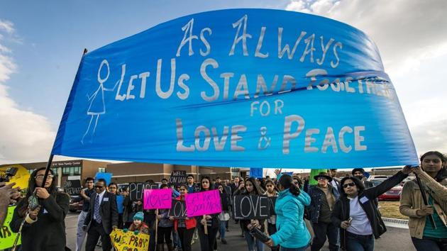 Hundreds of people march for peace on Sunday, Feb. 26, 2017, around the Ball Conference Center in Olathe, Kan., before starting a prayer vigil in response to the deadly shooting Wednesday. Adam Purinton was arrested hours after the attack and accused of shooting two Indian immigrants and a third man at a bar, in what some believe was a hate crime. (AP Photo) Hundreds of people march for peace on Sunday, Feb. 26, 2017, around the Ball Conference Center in Olathe, Kan., before starting a prayer vigil in response to the deadly shooting Wednesday. Adam Purinton was arrested hours after the attack and accused of shooting two Indian immigrants and a third man at a bar, in what some believe was a hate crime. (AP Photo)