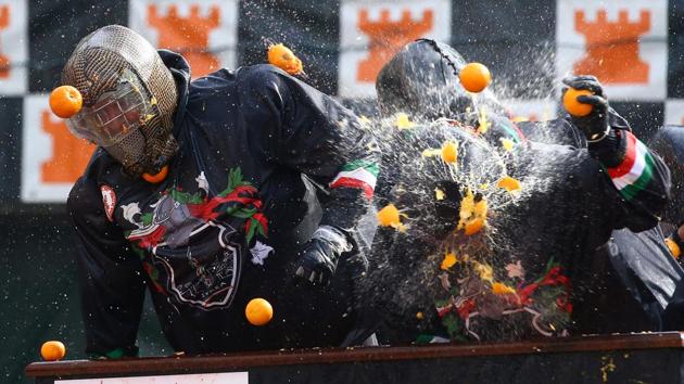 The Battle of the Oranges is a festival in the Northern Italian city of Ivrea, which includes a tradition of throwing of oranges between organized groups. (Stefano Rellandini/ REUTERS)