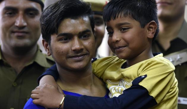 A seven year old boy with his uncle after the arrest of two accused who kidnapped him from Subhash Place area, at police headquarters in New Delhi. (Sonu Mehta/HT PHOTO) A seven year old boy with his uncle after the arrest of two accused who kidnapped him from Subhash Place area, at police headquarters in New Delhi. (Sonu Mehta/HT PHOTO)
