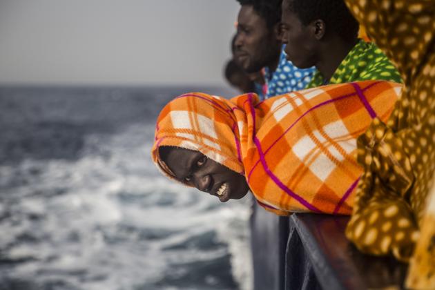 African refugees look at the sea aboard the Golfo Azurro, a rescue ship of the Spanish Proactiva Open Arms NGO, after being rescued from a boat out of control at 25 miles north of Sabratha, off the Libyan coast. (Santi Palacios / AP)