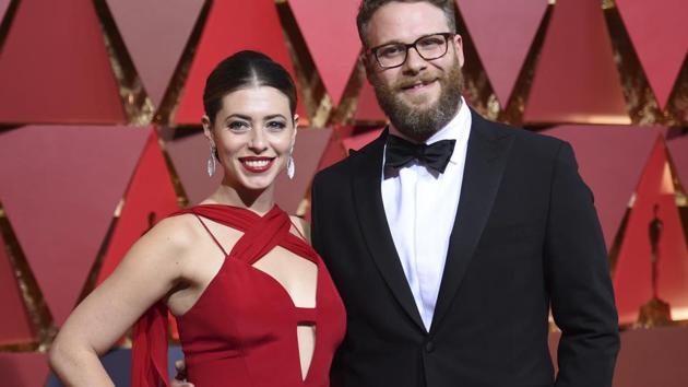 Seth Rogen (right) and Lauren Miller arrive at the Oscars on Monday. (AP)