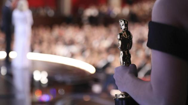 One of the best picture Oscar statuettes appears off stage as Warren Beatty and Faye Dunaway announce the best picture winner at the Oscars on Monday. (AP) One of the best picture Oscar statuettes appears off stage as Warren Beatty and Faye Dunaway announce the best picture winner at the Oscars on Monday. (AP)