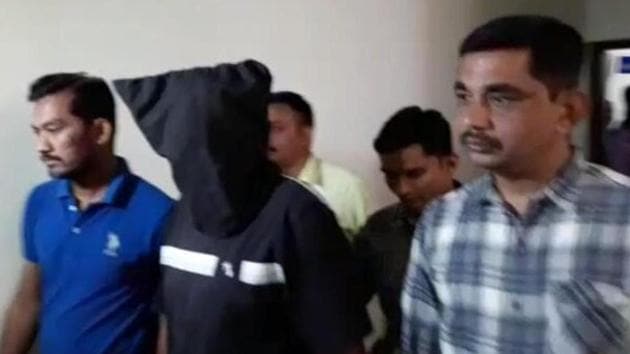 ATS personnel take one of the brothers, accused of having Islamic State links, into custody.(HT Photo)