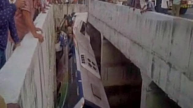 The bus rolled into a canal after crashing into a road divider in Andhra’s Krishna district early Tuesday. (ANI) The bus rolled into a canal after crashing into a road divider in Andhra’s Krishna district early Tuesday. (ANI)