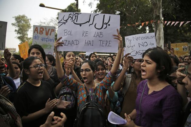 Students participate in a protest rally against the ABVP at Delhi University’s north campus on Tuesday. The placard reads, “Say that you are free to speak.”(AP photo)