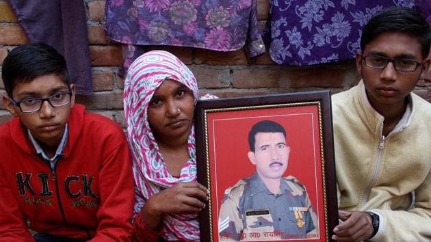 Family members of BSF head constable Rai Singh Indora holding his photograph at their residence in Kheri Sampla village in Rohtak. (Manoj Dhaka/HT Photo) Family members of BSF head constable Rai Singh Indora holding his photograph at their residence in Kheri Sampla village in Rohtak. (Manoj Dhaka/HT Photo)