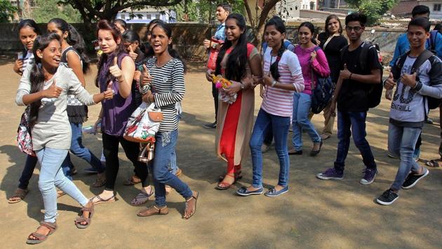 Students give the thumbs up sign after the first paper, at a Thane centre on Tuesday. (Praful Gangurde/HT PHOTO) 