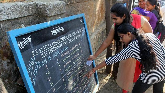 Students check their names and seat numbers on Day 1 of the state board Class 12 exams, in Thane on Tuesday. (Praful Gangurde/HT PHOTO) 