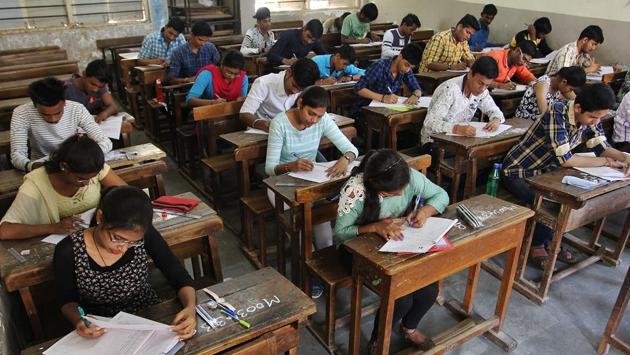 Inside a Thane centre, students get cracking as the exam papers are distributed. (Praful Gangurde/HTPHOTO) 