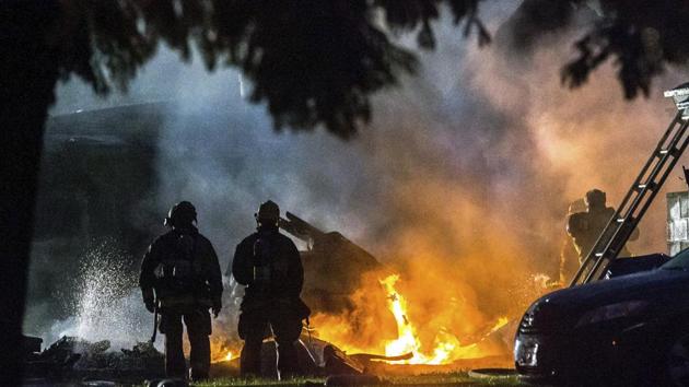 Firefighters put out flames after a plane crashed in Riverside, Calif., Monday, Feb. 27, 2017. The deadly crash injured several when a small plane collided with two homes Monday shortly after taking off from a nearby airport, officials said.(AP Photo)